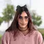Person with sunglasses and cat ears headband