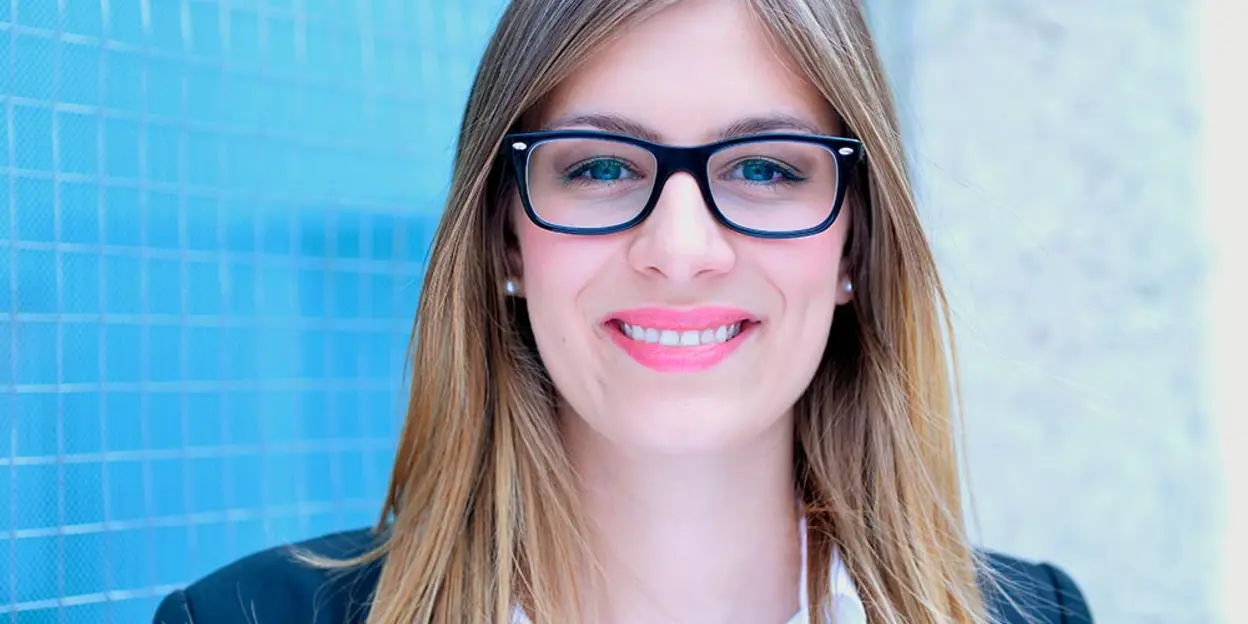 Smiling woman with glasses and long hair
