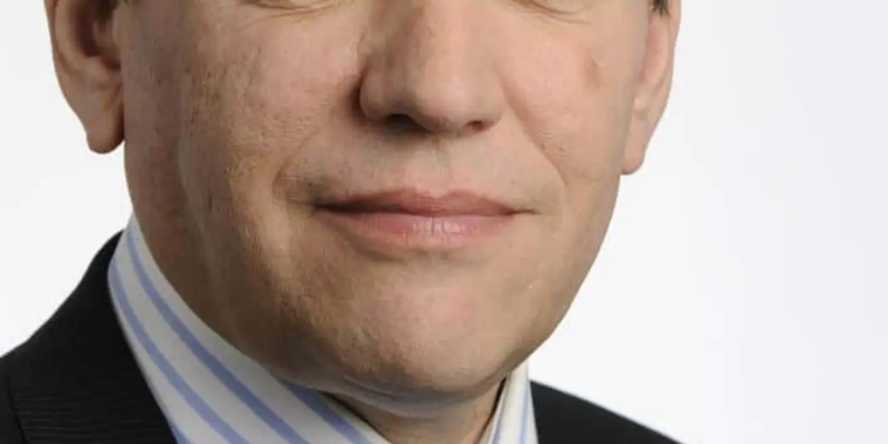 Man in suit and blue tie, striped shirt