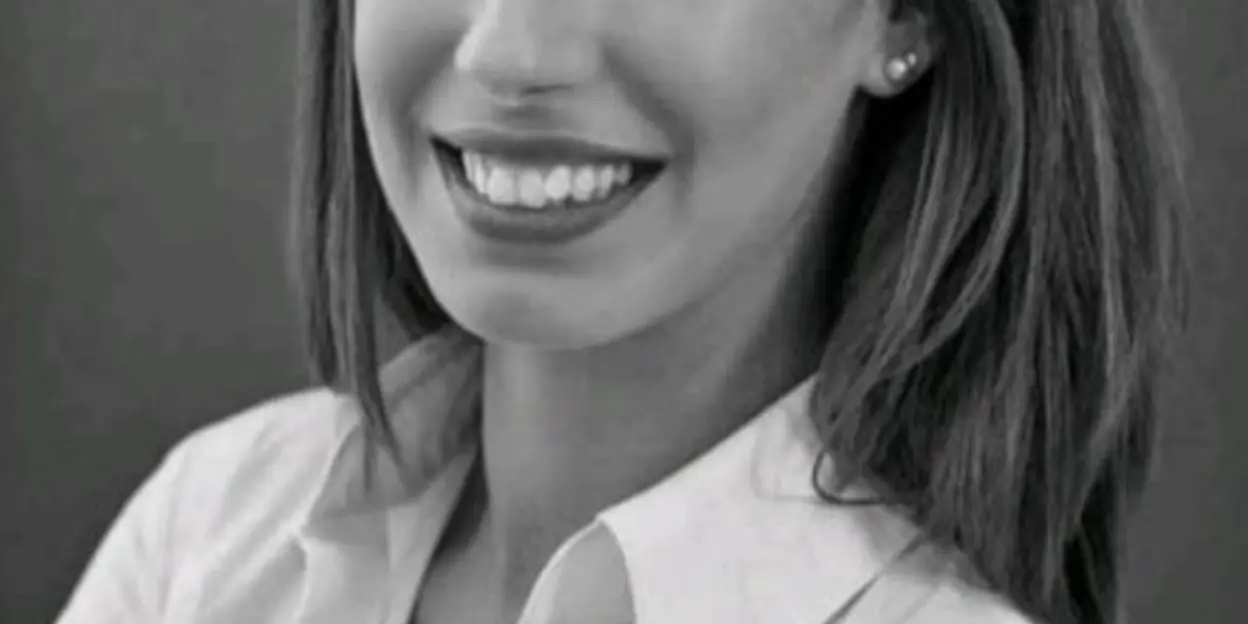 Portrait of a smiling woman with long hair in black and white