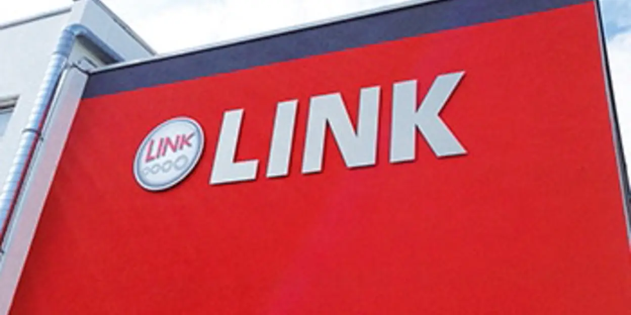 A large red sign with the word LINK against a blue sky