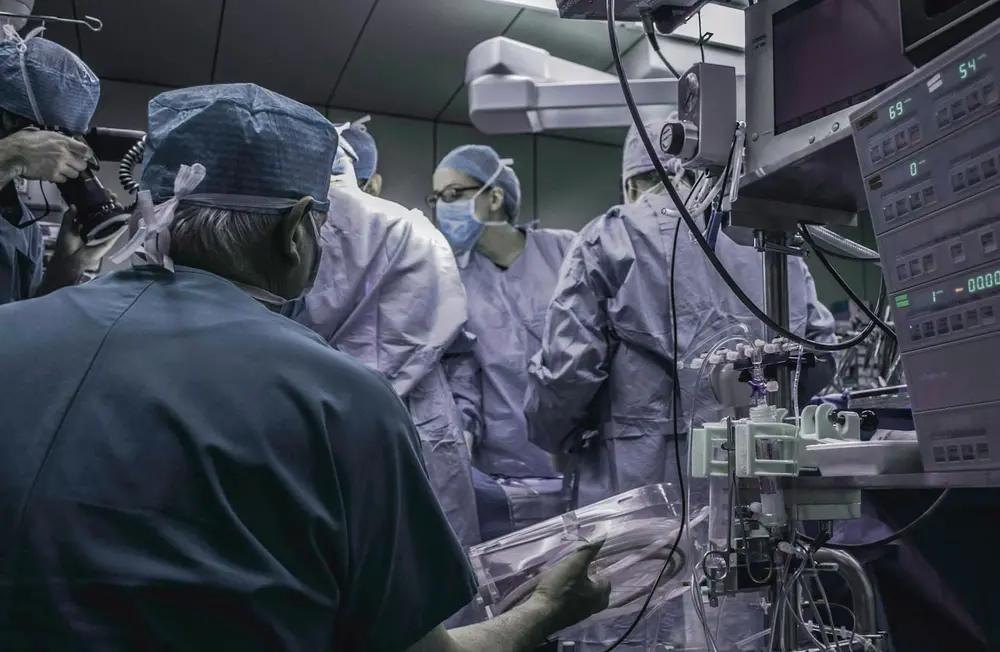 Medical team working in an operating room with equipment