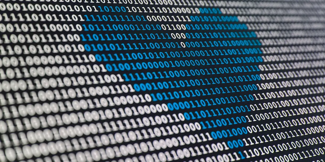 Close-up of binary code with blue shape